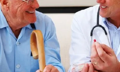 old man with doctor giving pills